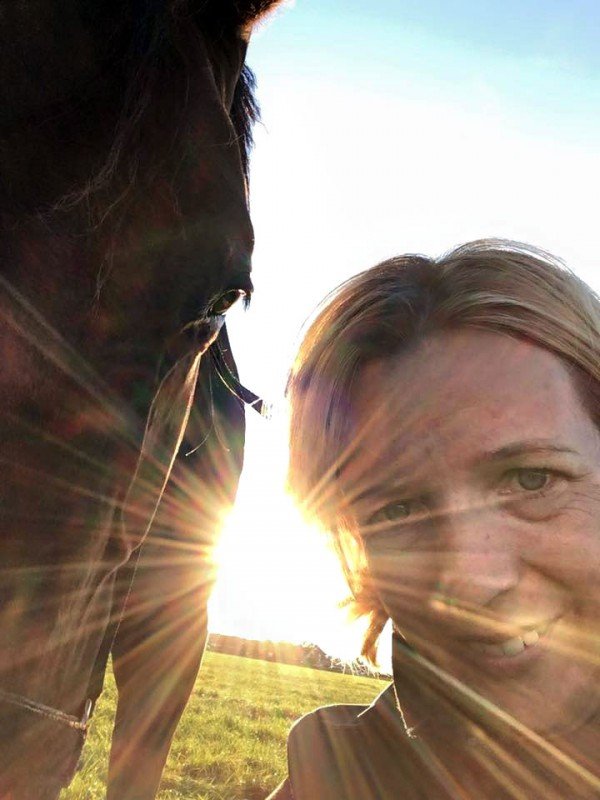 Rianne Sibma with horse in evening sun, Rottum, The Netherlands